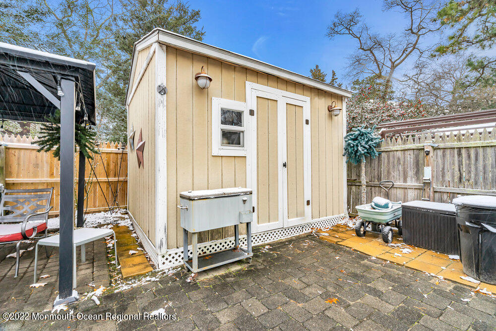 51 Dock Road Brick, NJ 08723 - Photo 52 of 57 a view of patio with a table and chairs and floor to ceiling window