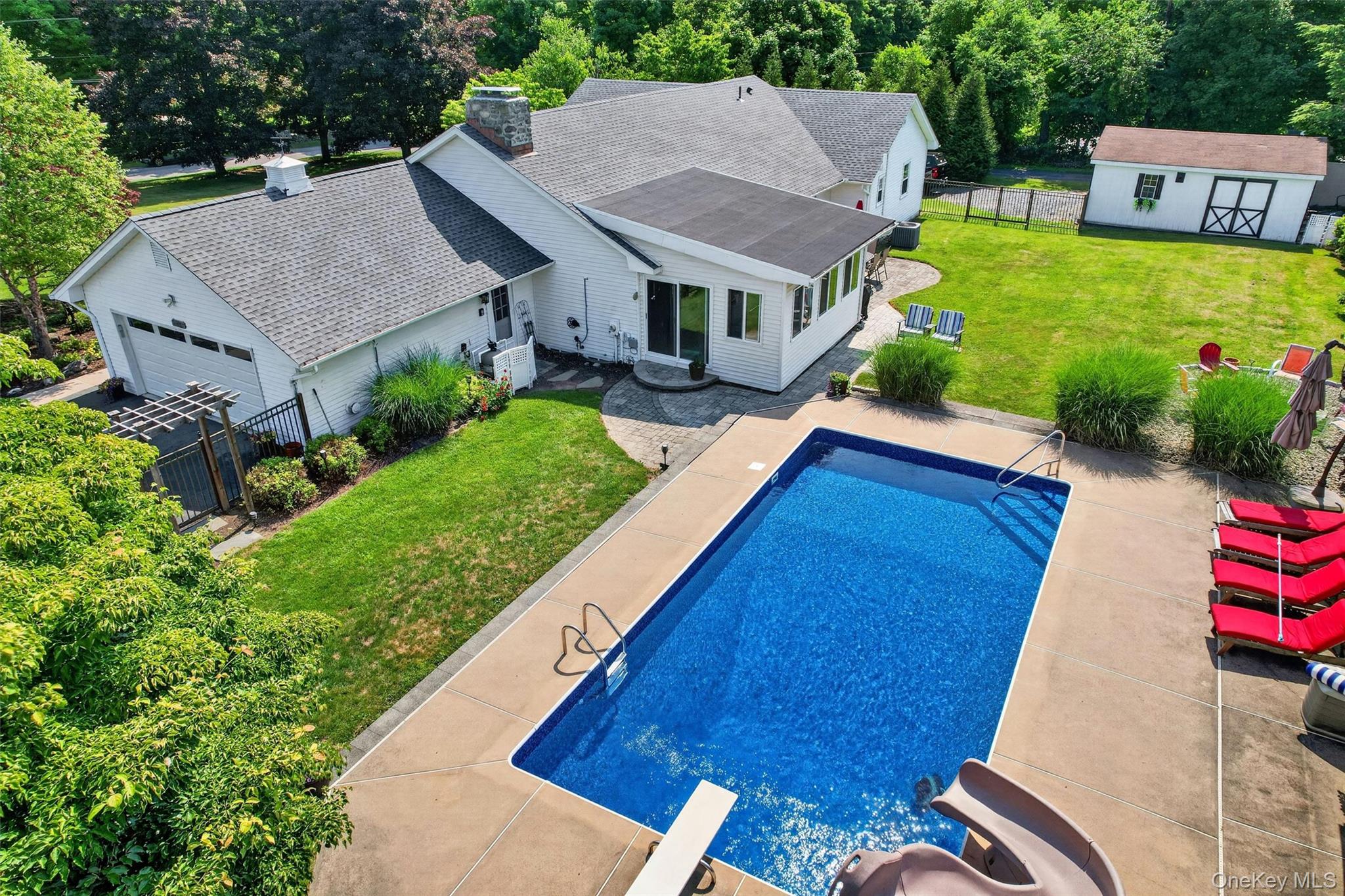 5 Hedges Road Warwick, NY 10990 - Photo 47 of 48 An aerial look at the backyard retreat, featuring the pool, patios, lawn space, privacy fencing, and detached garage.
