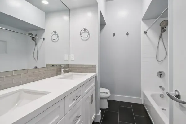 a bathroom with a sink a toilet and a bathtub