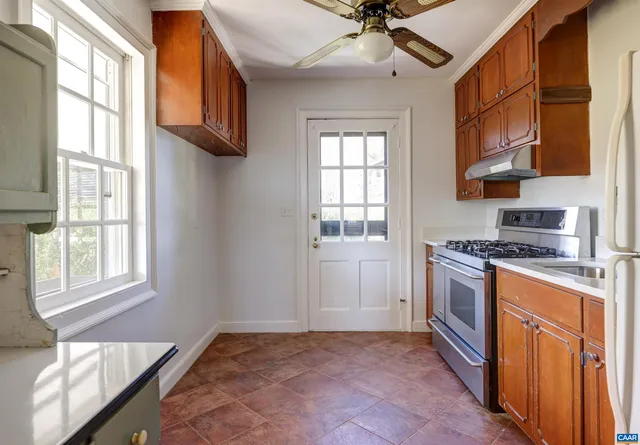 a kitchen with stainless steel appliances granite countertop a stove and a refrigerator