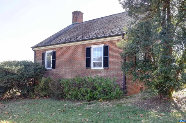 a front view of a house with plants