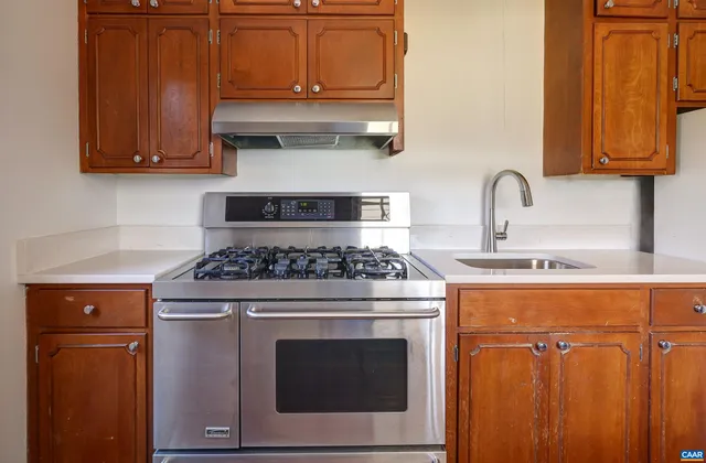 a stove top oven sitting inside of a kitchen