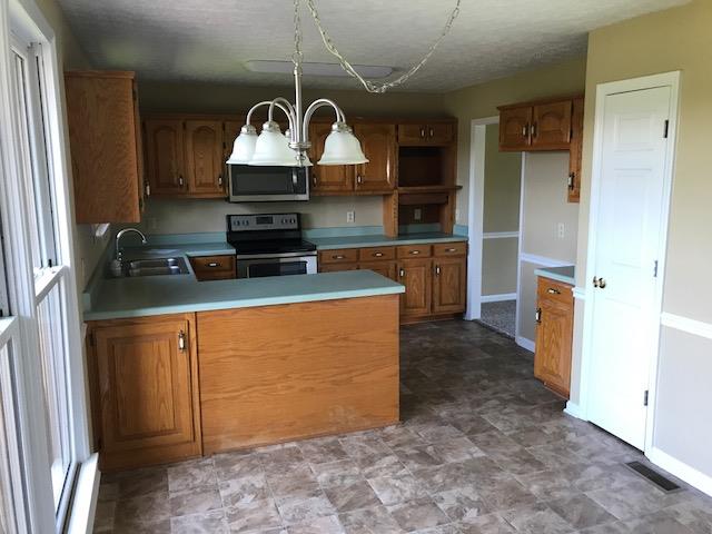 1005 Mohawk Trail Springfield, TN 37172 - Photo 3 of 10 a kitchen with stainless steel appliances granite countertop a refrigerator a stove and a sink