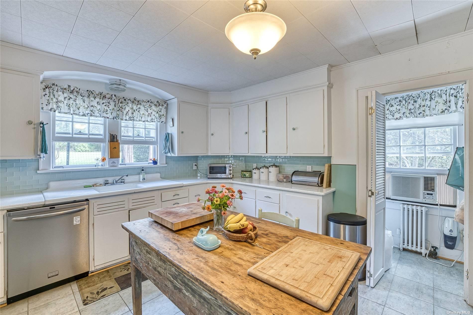 1695 Old Wood Path Southold, NY 11971 - Photo 14 of 32 a kitchen with a sink stove and cabinets