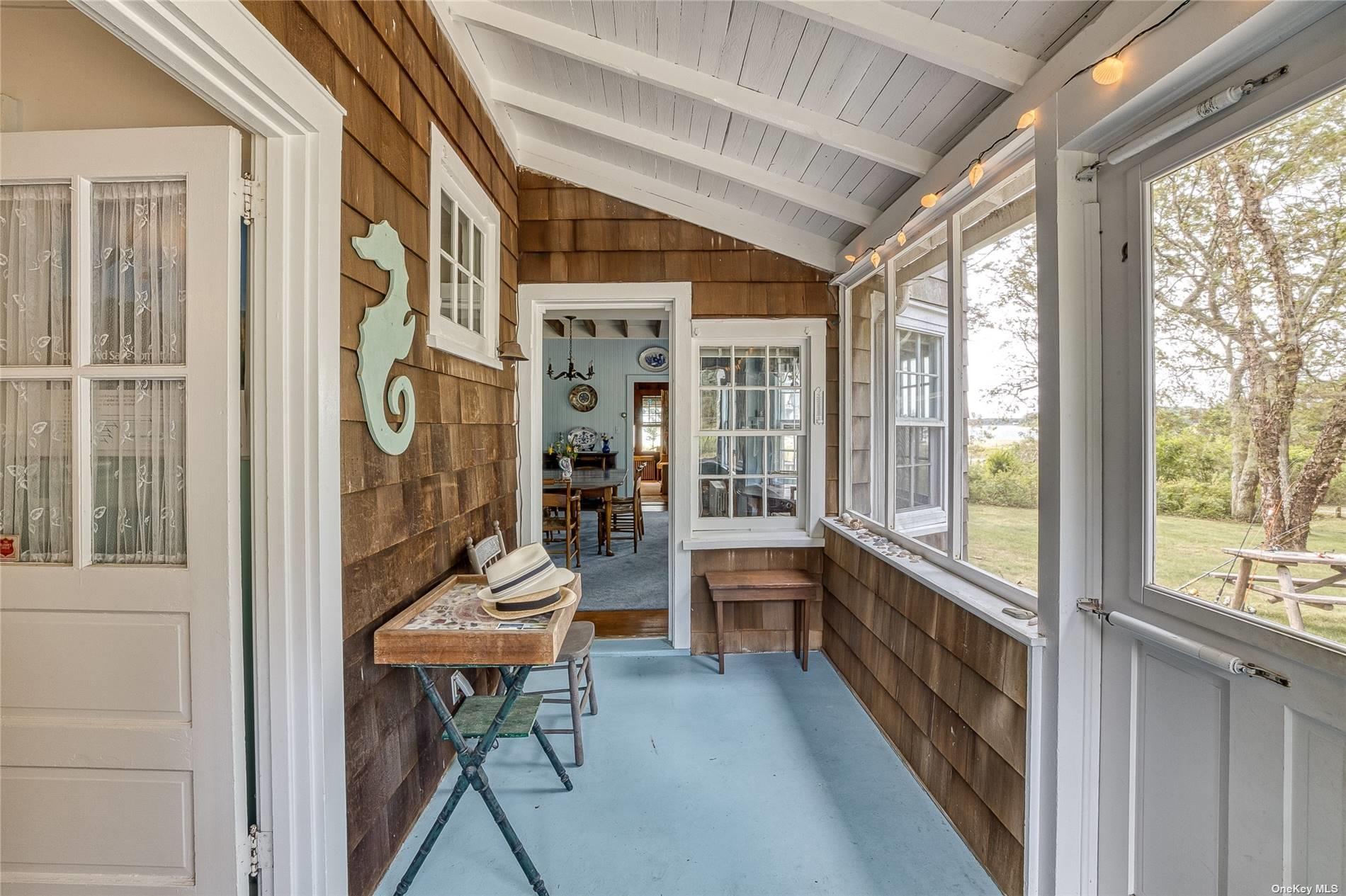 1695 Old Wood Path Southold, NY 11971 - Photo 16 of 32 a room with furniture and large windows