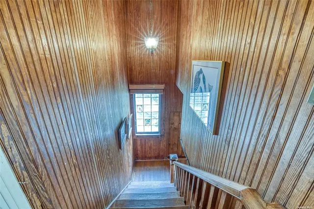 a view of a room with wooden staircase