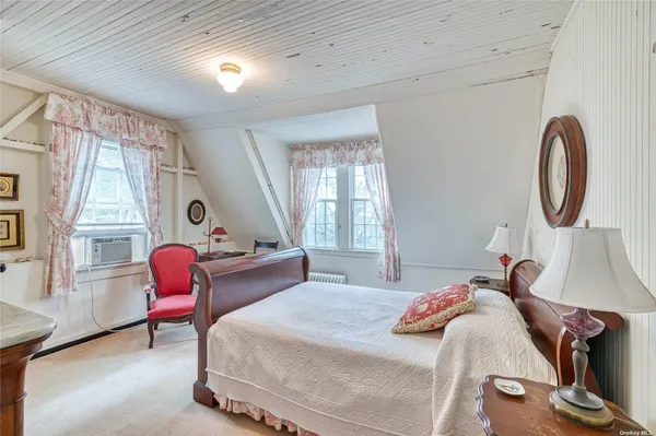 a bedroom with bed and a window