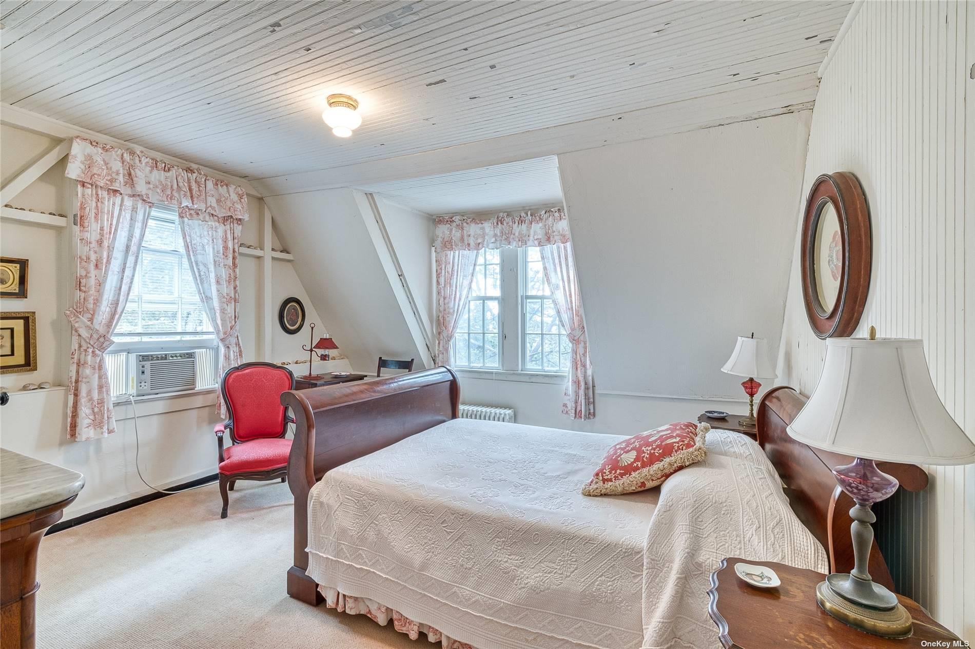 1695 Old Wood Path Southold, NY 11971 - Photo 19 of 32 a bedroom with bed and a window