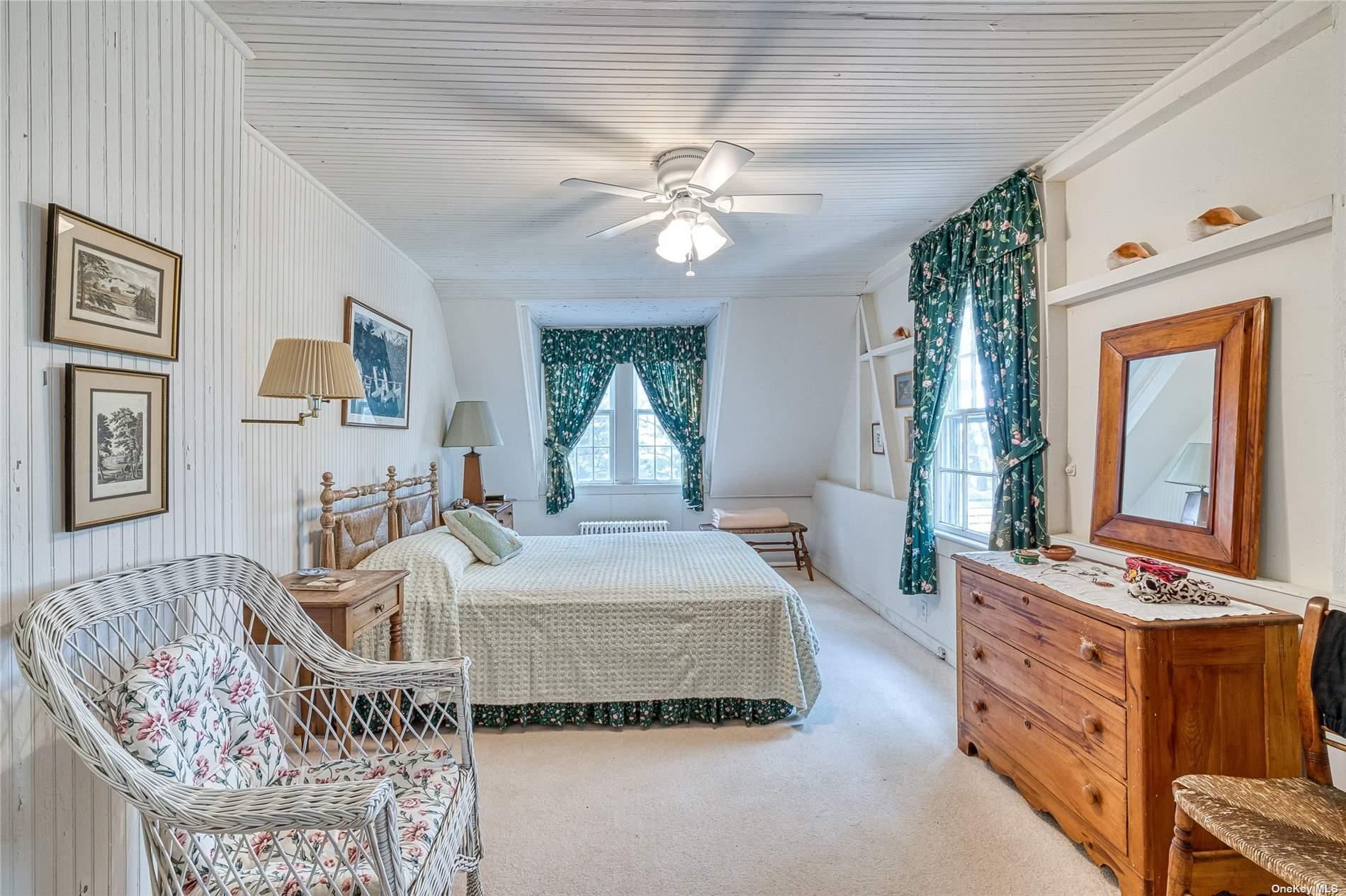 1695 Old Wood Path Southold, NY 11971 - Photo 20 of 32 a living room with furniture and a flat screen tv