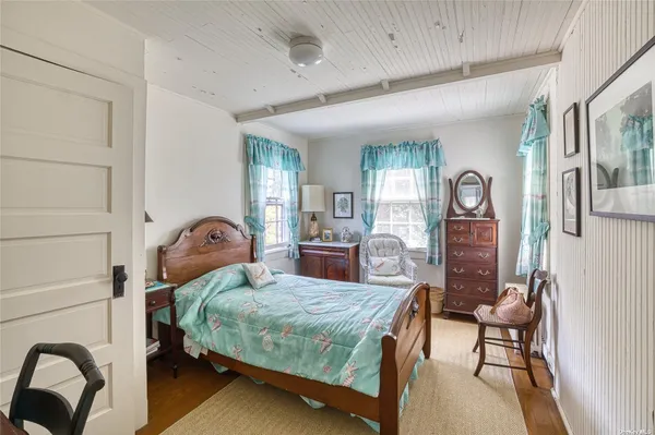 a bedroom with a large bed and a dresser