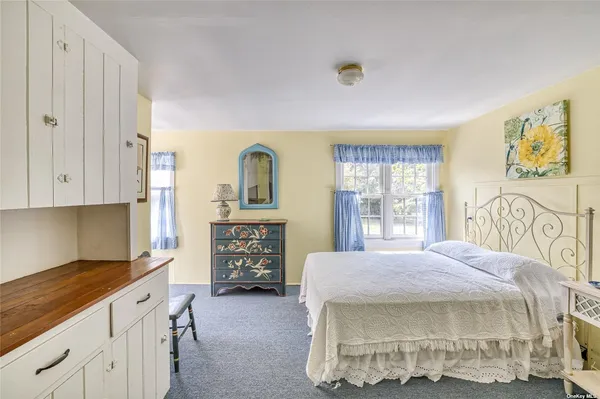 a spacious bedroom with a bed and a cabinets