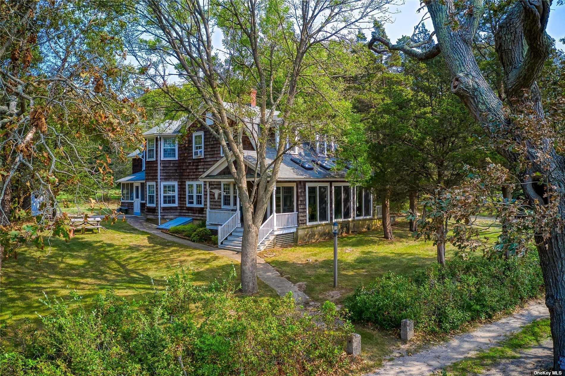 1695 Old Wood Path Southold, NY 11971 - Photo 28 of 32 a view of a house with a small yard
