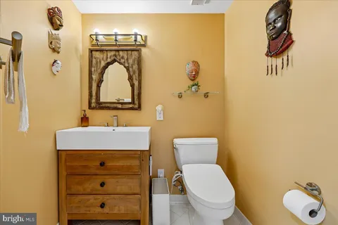 a living room with fireplace furniture and a large window