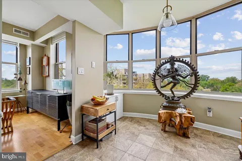 a living room with patio furniture and a table