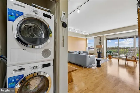 a large tub sitting in a bathroom next to a white cabinet