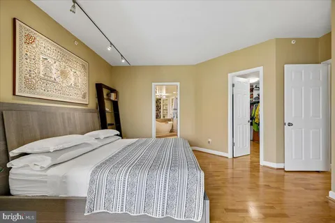 a bed sitting in a bedroom next to a window