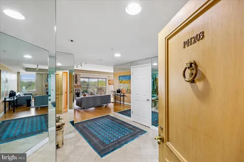 a kitchen with stainless steel appliances kitchen island granite countertop a refrigerator and a sink