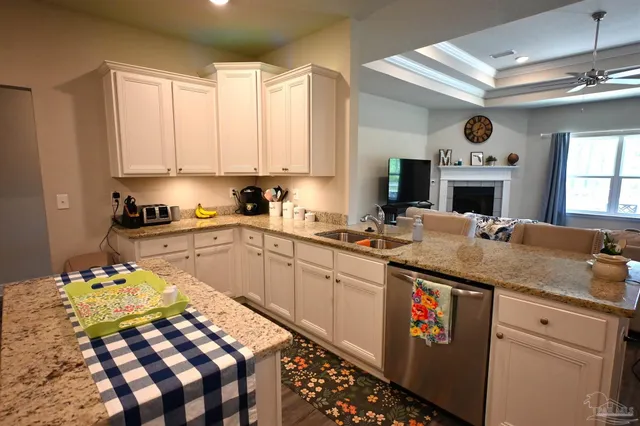 a kitchen with a sink a counter top space stainless steel appliances and cabinets