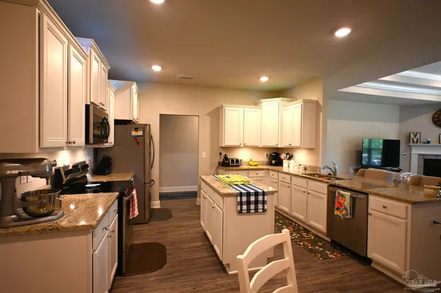 a kitchen with a appliances and a window