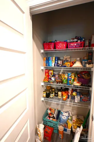 a dining room with furniture and a floor to ceiling window