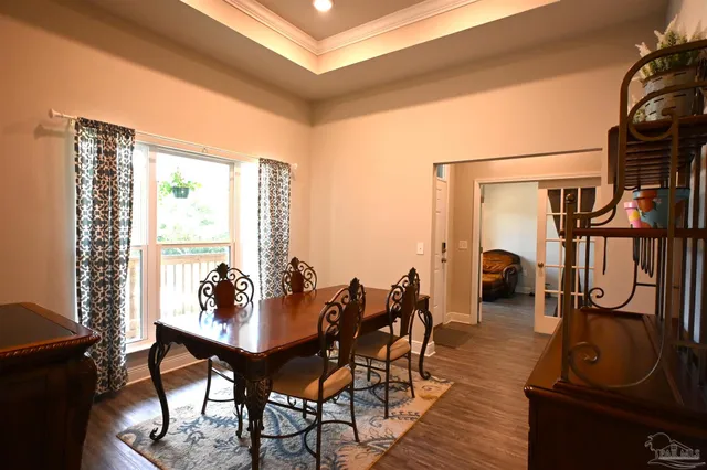 a view of a dining room with furniture and window