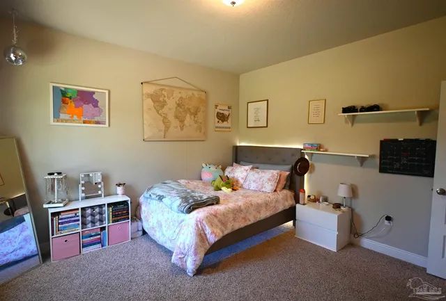 a bedroom with a bed and flat screen tv