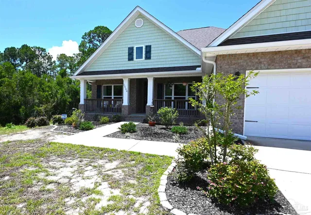 a front view of a house with garden