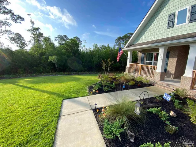 a front view of a house with garden