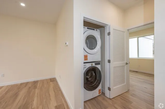 a view of a hallway with washer and dryer