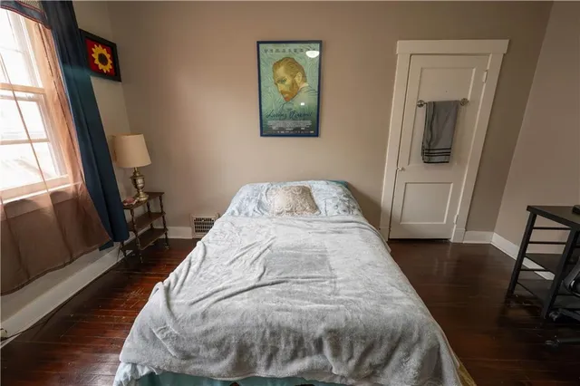 a view of bedroom with window and hardwood floor