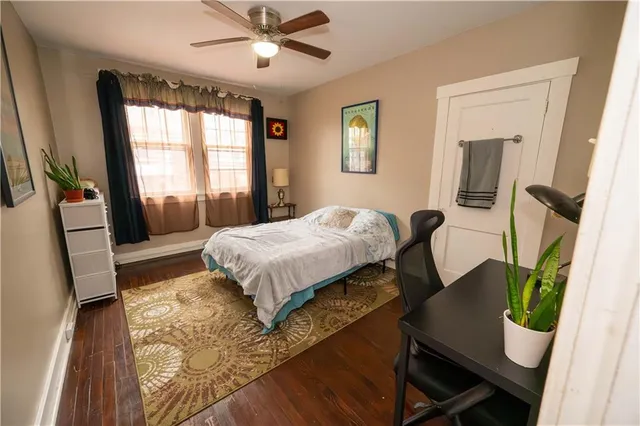 a bedroom with a bed window and a desk