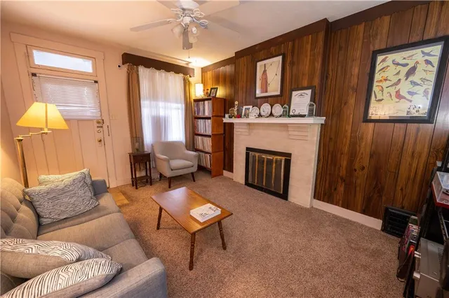 a living room with furniture a fireplace and a window