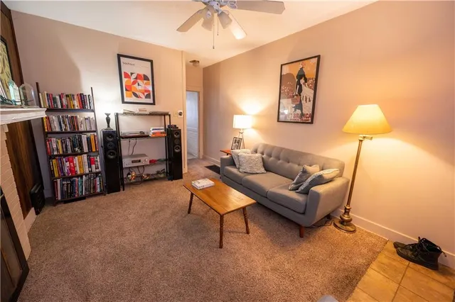 a living room with furniture and a book shelf