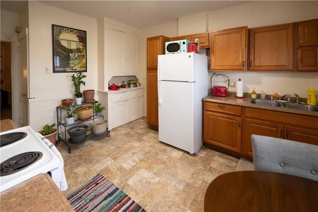 a kitchen with a refrigerator and a stove