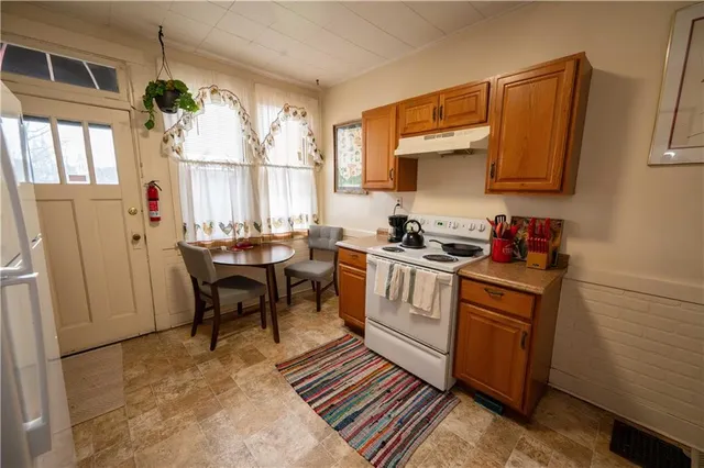 a kitchen with a refrigerator and a table