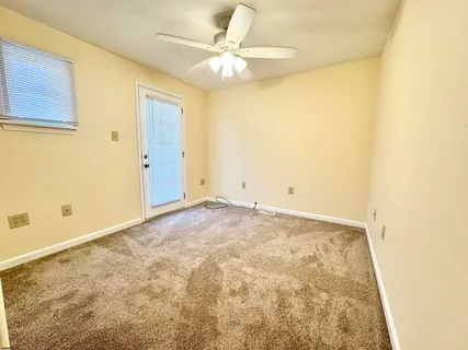 a view of a room with a ceiling fan