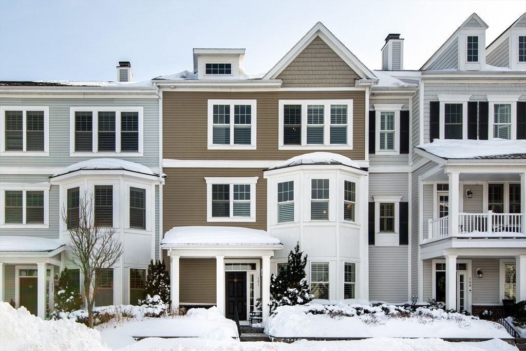 a front view of a residential apartment building with a yard