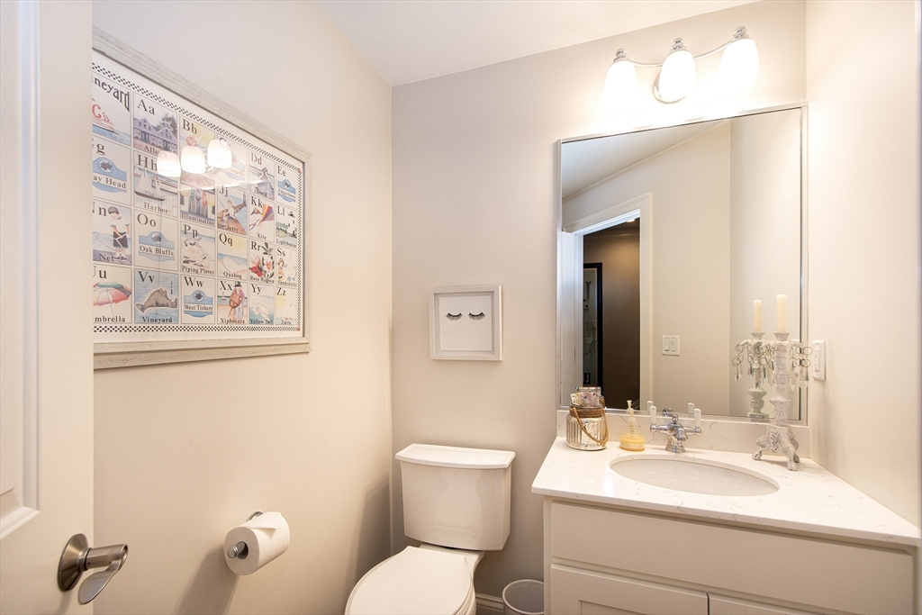 151 HMS Stayner Drive, Unit 151 Hingham, MA 02043 - Photo 11 of 42 a bathroom with a toilet a sink and mirror