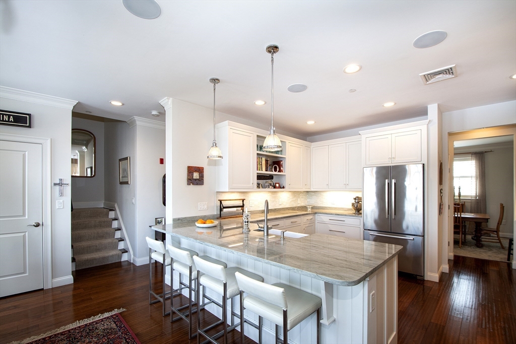151 HMS Stayner Drive, Unit 151 Hingham, MA 02043 - Photo 17 of 42 a kitchen with stainless steel appliances granite countertop a refrigerator a sink and a stove
