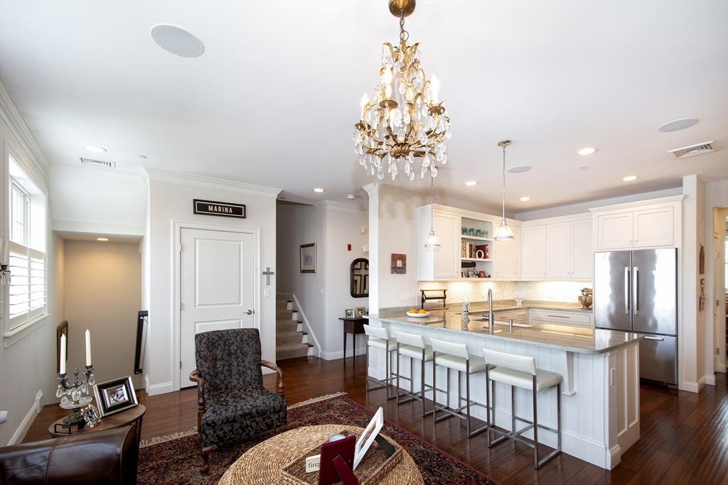 151 HMS Stayner Drive, Unit 151 Hingham, MA 02043 - Photo 19 of 42 a living room with stainless steel appliances kitchen island granite countertop furniture and a dining table