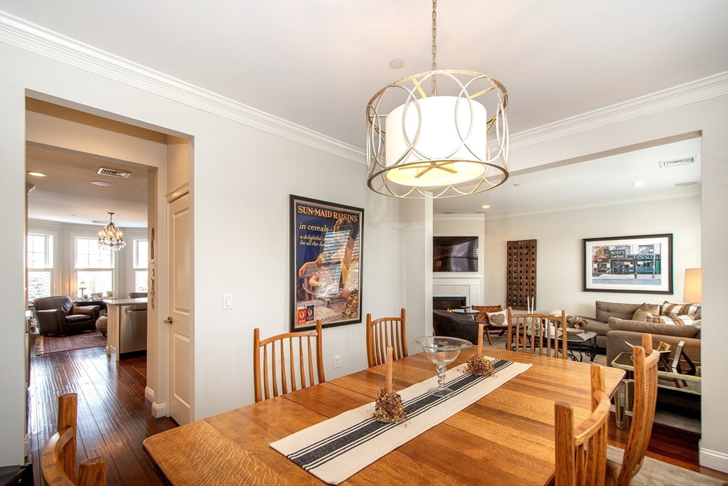 151 HMS Stayner Drive, Unit 151 Hingham, MA 02043 - Photo 24 of 42 a view of a dining room with furniture a chandelier and wooden floor