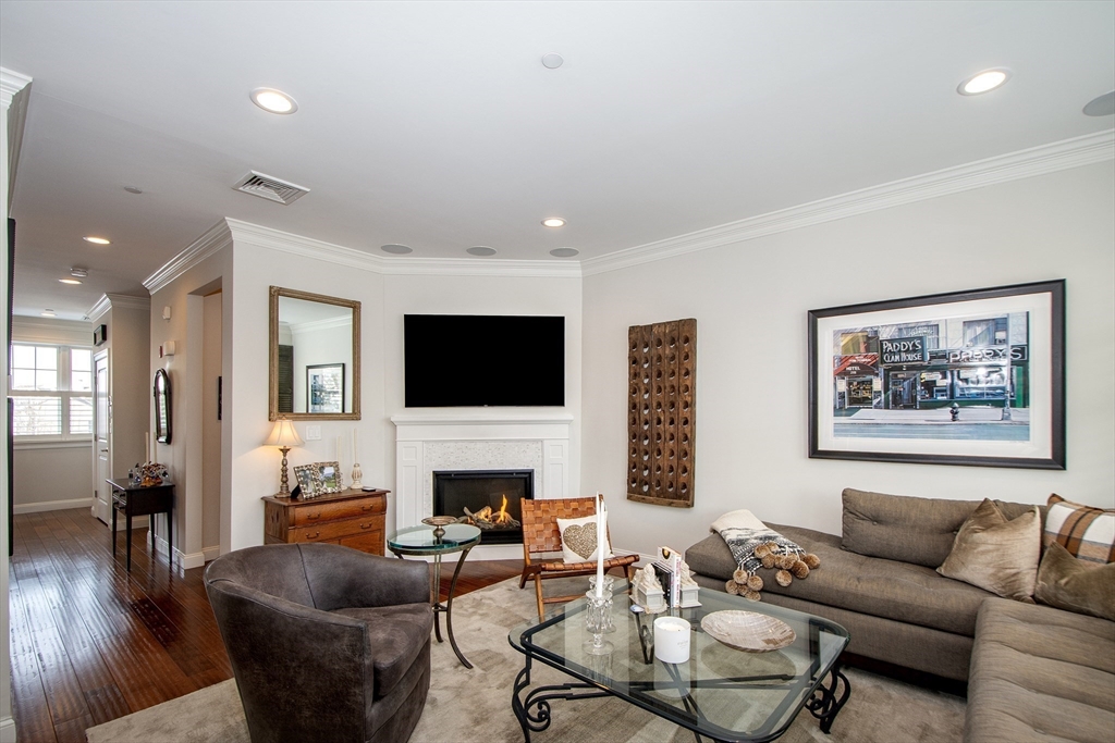 151 HMS Stayner Drive, Unit 151 Hingham, MA 02043 - Photo 26 of 42 a living room with furniture fireplace and a flat screen tv