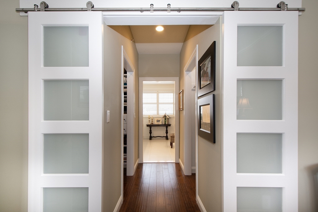 151 HMS Stayner Drive, Unit 151 Hingham, MA 02043 - Photo 35 of 42 a view of a hallway with wooden floor and a glass door