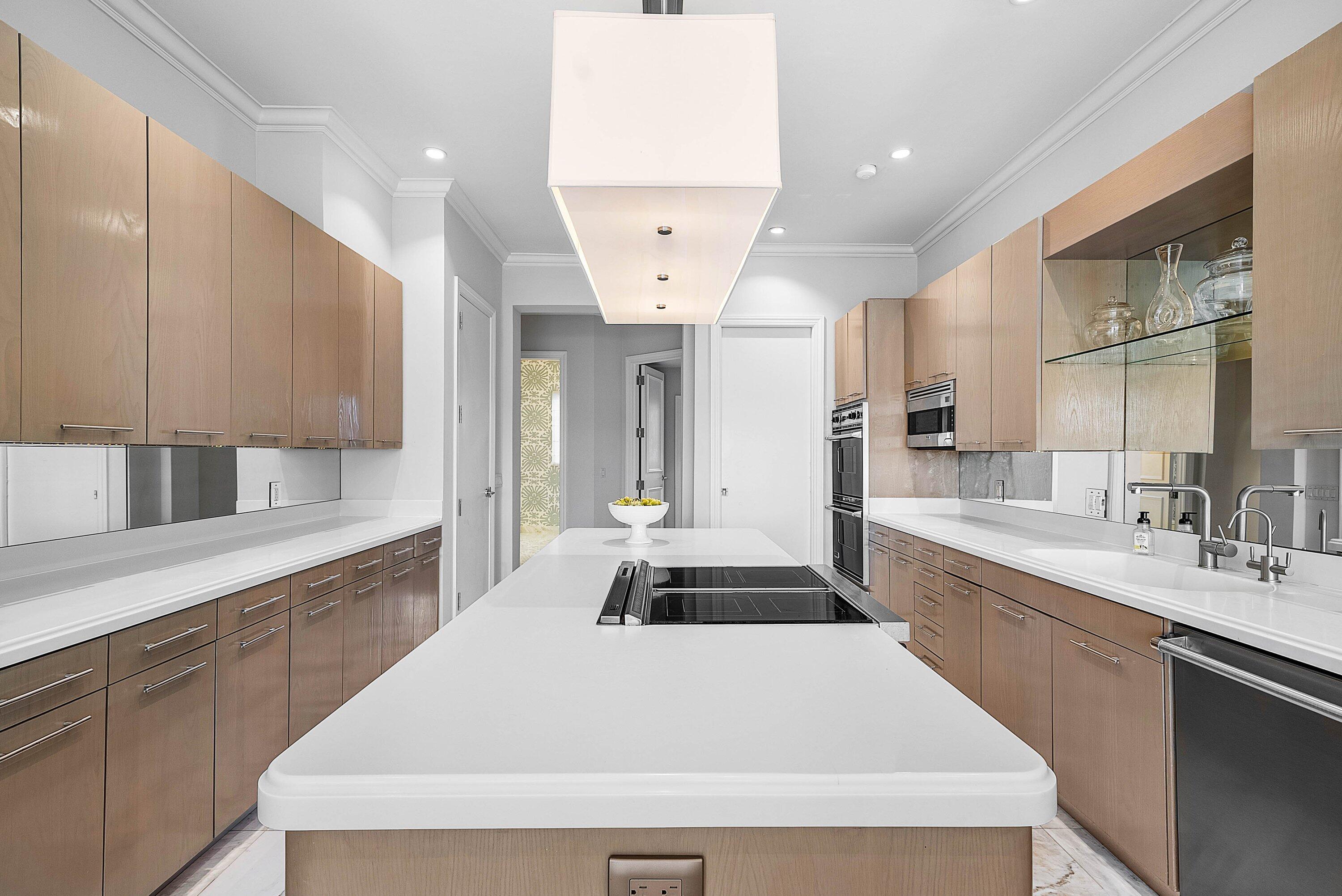 1620 Lands End Road Manalapan, FL 33462 - Photo 15 of 34 a large kitchen with a large counter top space a sink stainless steel appliances and cabinets