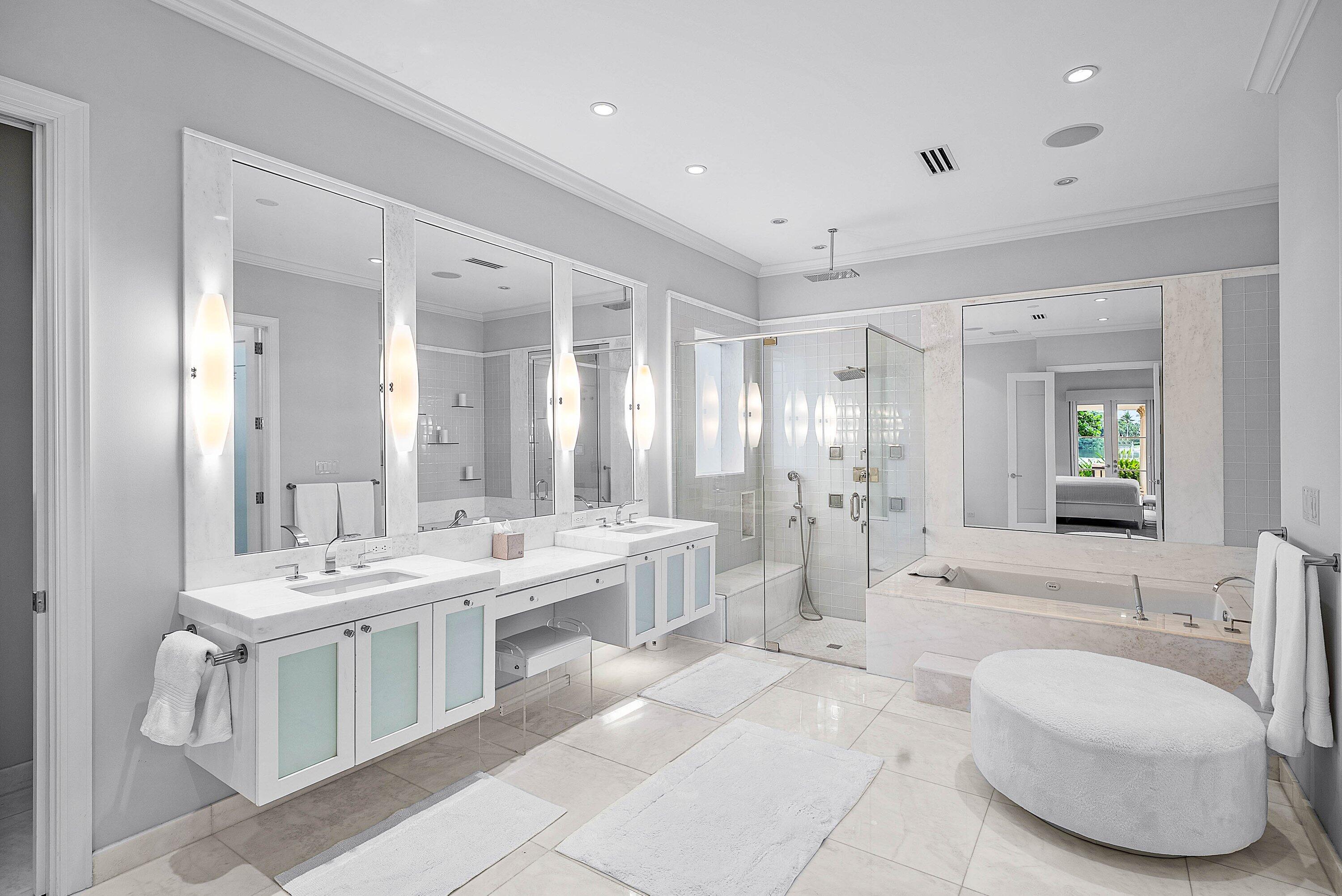 1620 Lands End Road Manalapan, FL 33462 - Photo 20 of 34 a large white bathroom with a double vanity sink a mirror and a bathtub