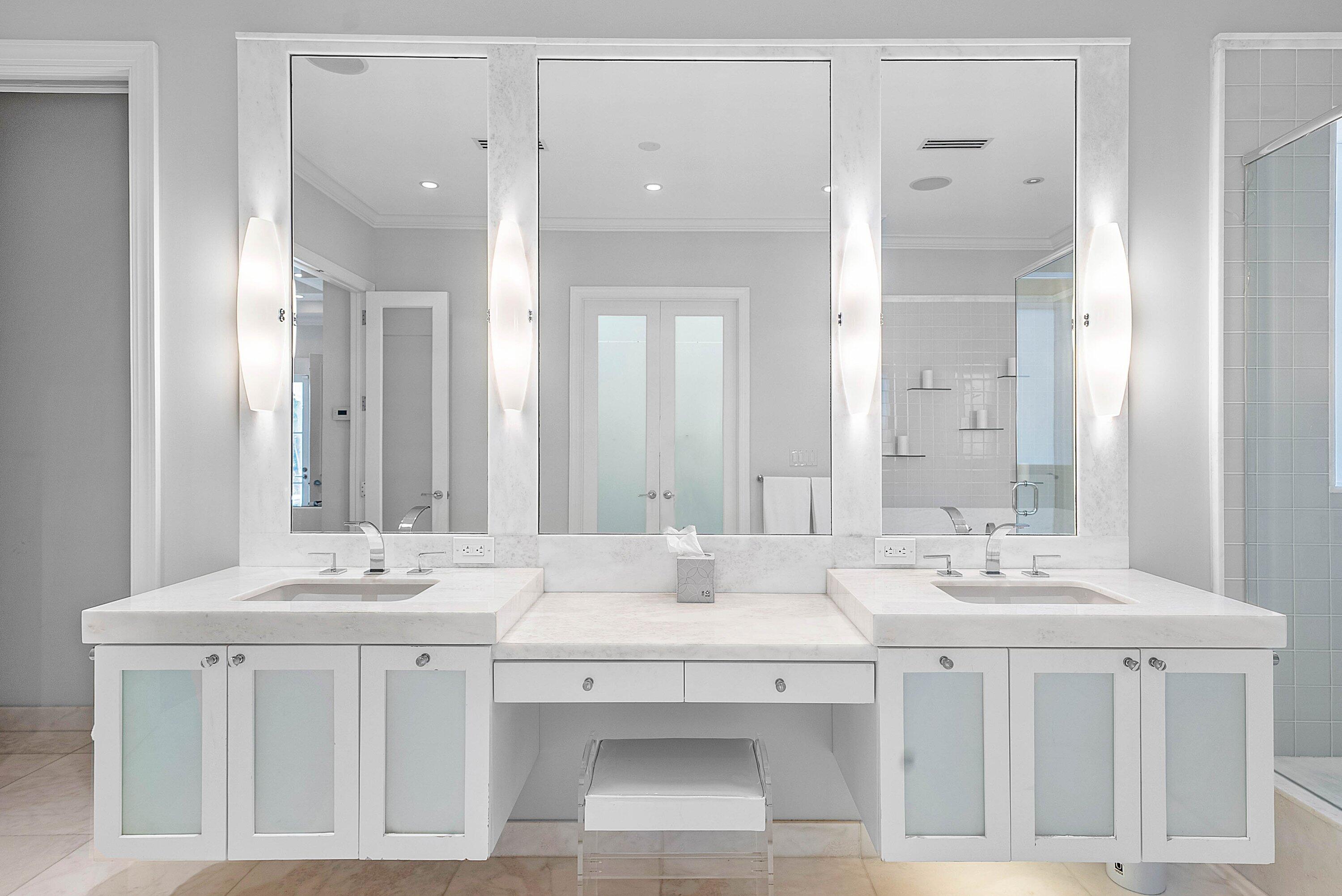 1620 Lands End Road Manalapan, FL 33462 - Photo 21 of 34 a bathroom with a sink vanity and a mirror