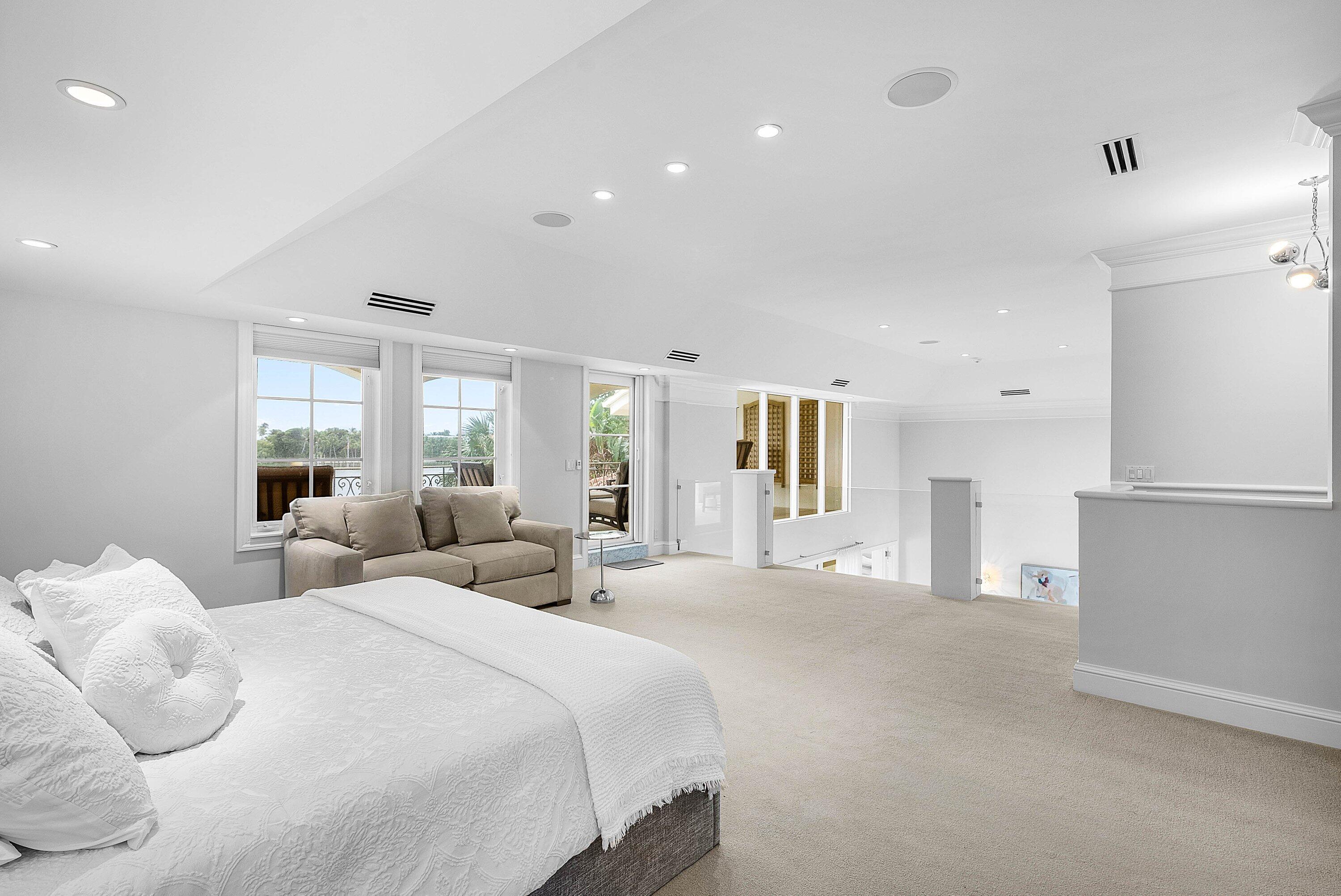 1620 Lands End Road Manalapan, FL 33462 - Photo 25 of 34 a large bedroom with a large bed and windows