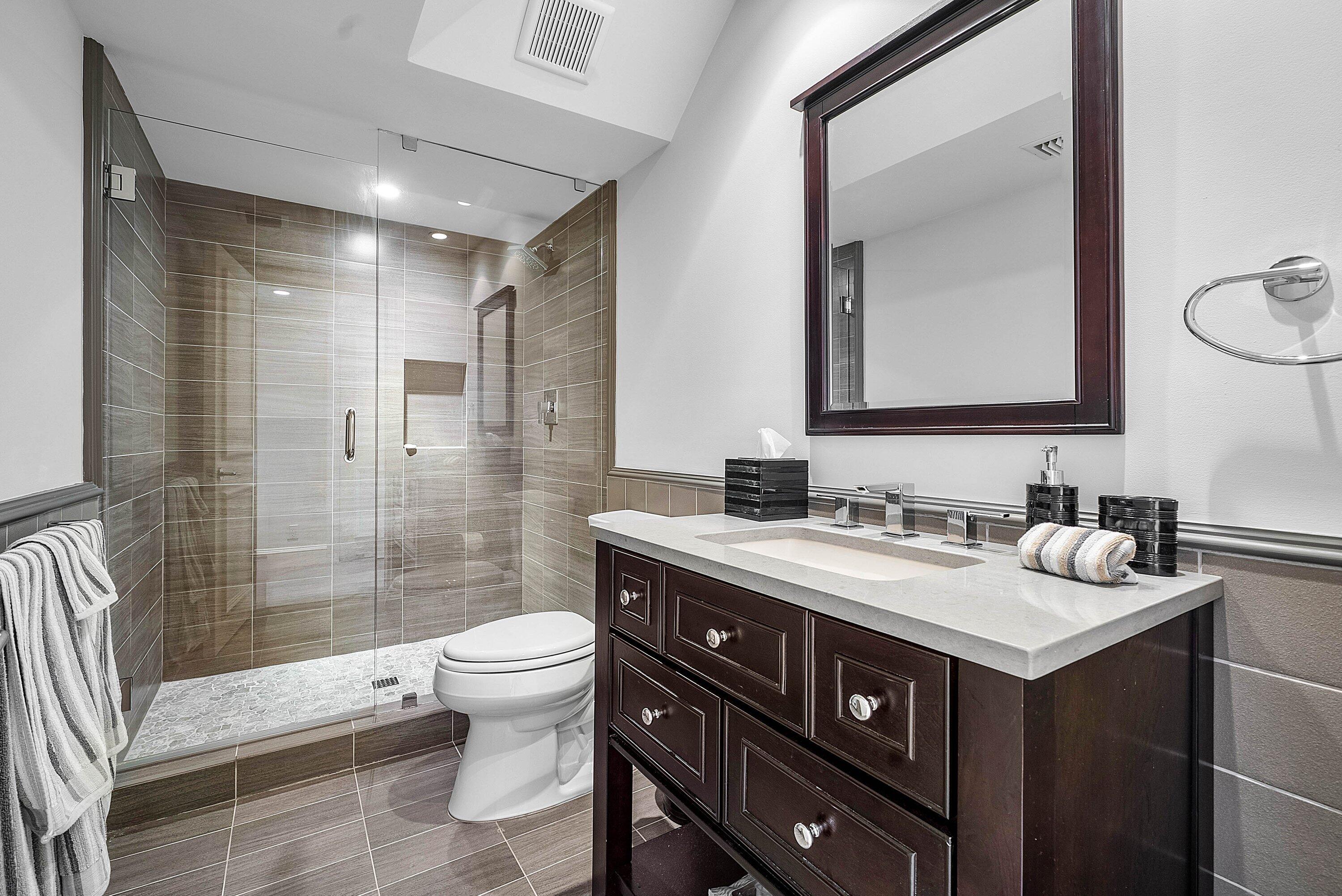 1620 Lands End Road Manalapan, FL 33462 - Photo 27 of 34 a bathroom with a sink vanity toilet and shower