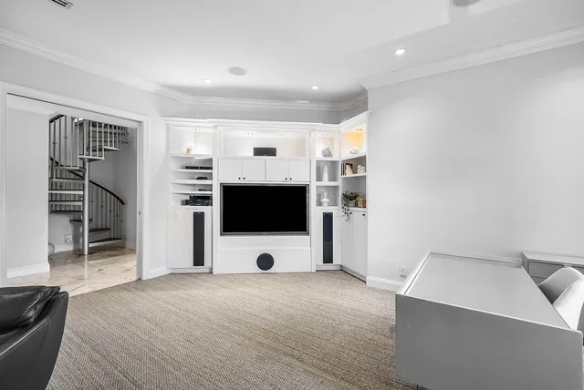 a view of a patio with table and chairs potted plants and floor to ceiling window