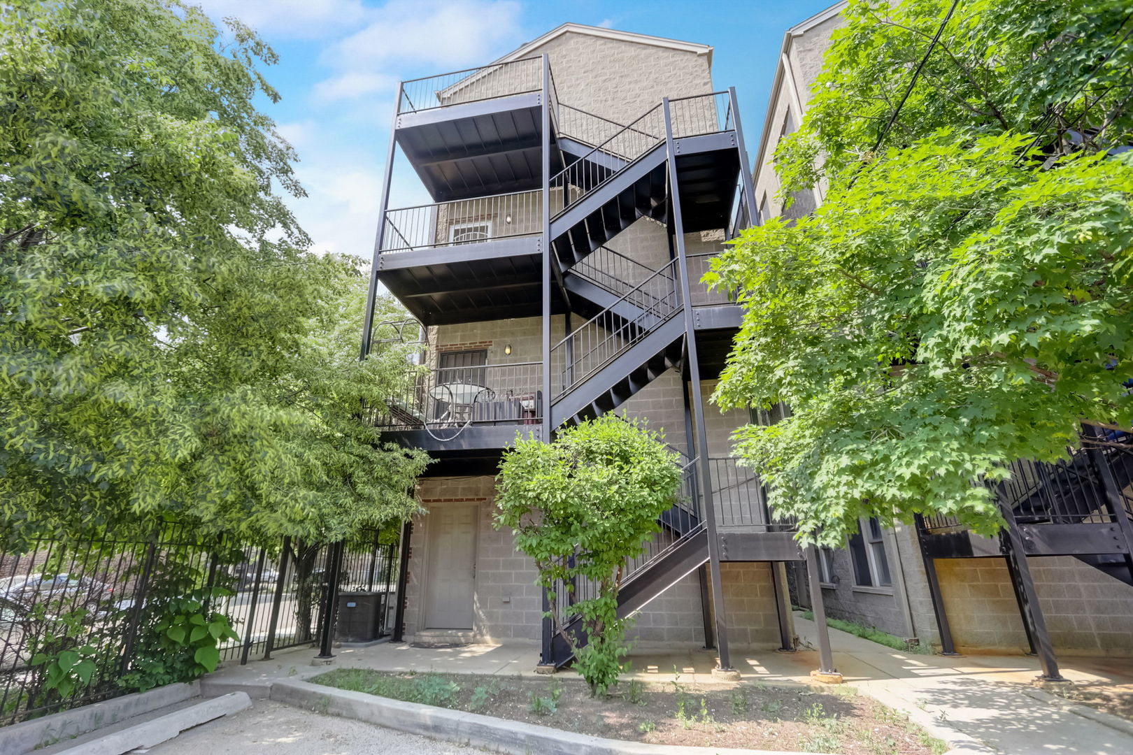 2457 West Harrison Street, Unit 3 Chicago, IL 60612 - Photo 18 of 20 a house with trees in front of it